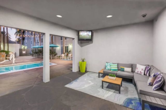 Couches TV rug pool area exterior at University Village Towers in Riverside Student Accommodation