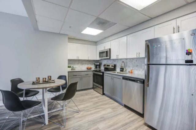 Round table four chairs stainless steel refrigerator kitchen at University Village Towers in Riverside Student Accommodation