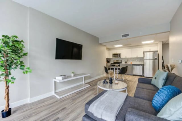 Living room with kitchen and couch living room at University Village Towers in Riverside Student Accommodation