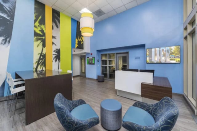 Chairs table reception desk TV lobby area at University Village Towers in Riverside Student Accommodation