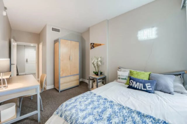Bed desk wardrobe neon sign bedroom at University Village Towers in Riverside Student Accommodation