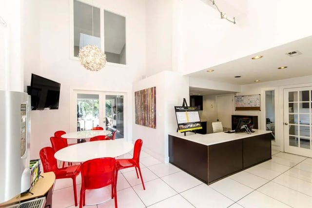 Reception desk with tables chairs TV communal area at Hawks Pointe in Lawrence Student Accommodation