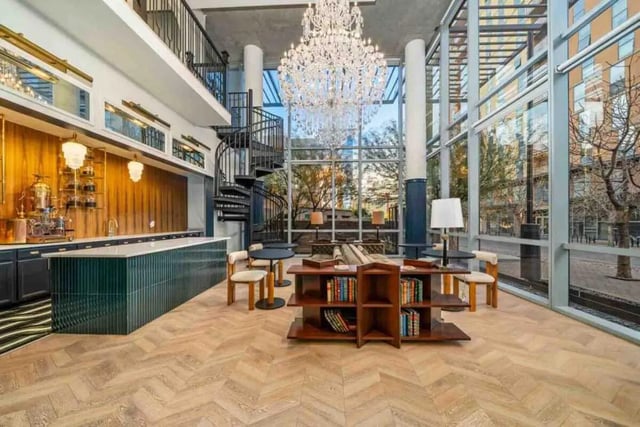 Bar coffee station spiral stairs chandelier living room exterior at Vesper Holdings