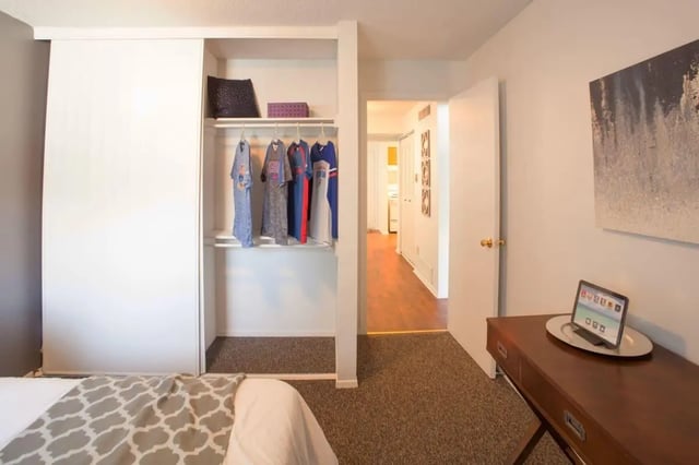 Closet with clothes desk with tablet hallway exterior bedroom at Hawks Pointe in Lawrence Student Accommodation