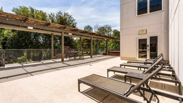 Loungers and tables under a pergola outdoor area at The Vista Apartments in Boise Student Accommodation