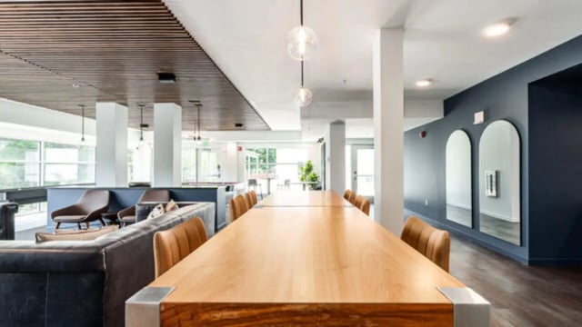 Communal tables sofas chairs mirrors living area at The Vista Apartments in Boise Student Accommodation