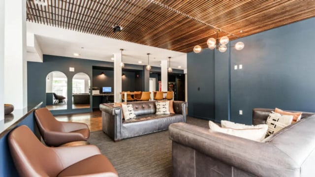 Leather sofas chairs and tables study area living room at The Vista Apartments in Boise Student Accommodation