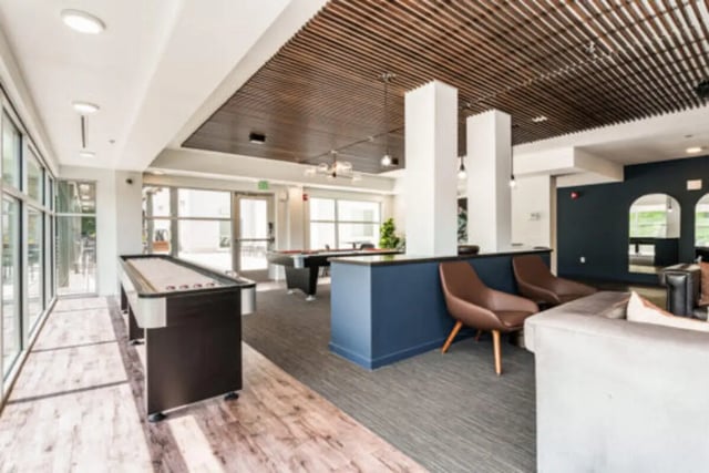 Shuffleboard pool tables seating common area lounge at The Vista Apartments in Boise Student Accommodation