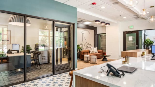 Office reception desk with seating and Idaho map at The Vista Apartments in Boise Student Accommodation