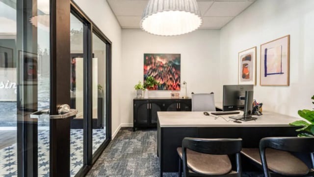 Desk with computer paintings and cabinet office at The Vista Apartments in Boise Student Accommodation