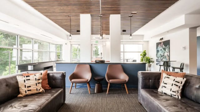 Two leather sofas, chairs, artwork, lounge area at The Vista Apartments in Boise Student Accommodation