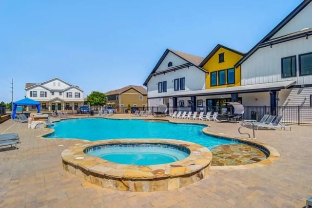 Pool and hot tub with lounge chairs exterior at The Collective At Auburn in Auburn Student Accommodation