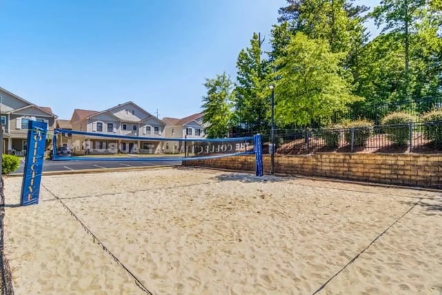 Sand volleyball court with buildings exterior at The Collective At Auburn in Auburn Student Accommodation