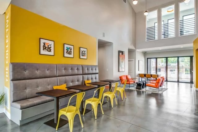 Yellow chairs tufted banquette art living room at The Collective At Auburn in Auburn Student Accommodation