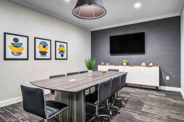 Conference table chairs artwork television modern meeting room at The Collective At Auburn in Auburn Student Accommodation
