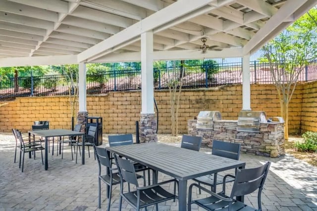 Tables chairs grills under covered patio area at The Collective At Auburn in Auburn Student Accommodation
