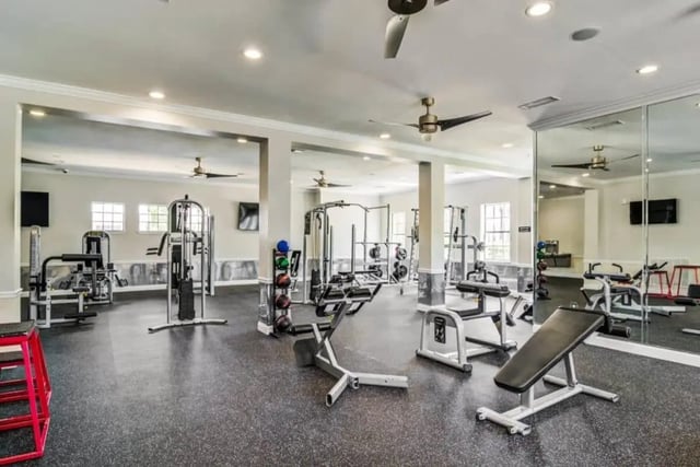 Weight machines exercise benches mirrored walls fitness gym at The Collective At Auburn in Auburn Student Accommodation
