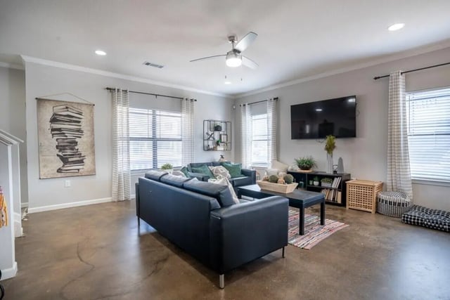 Dark sofas coffee table and TV living room at The Collective At Auburn in Auburn Student Accommodation