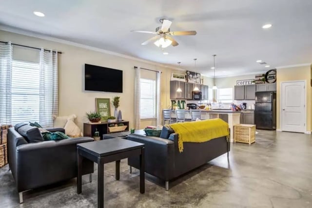 Two sofas coffee table kitchen living room at The Collective At Auburn in Auburn Student Accommodation