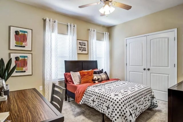Bed with patterned duvet and pillows bedroom at The Collective At Auburn in Auburn Student Accommodation