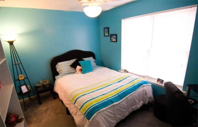 Bed with striped blankets and pillows bedroom at Method Townhomes in Raleigh Student Accommodation