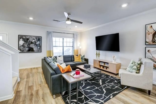 Sectional sofa coffee tables large TV living room at The Collective At Clemson in Clemson Student Accommodation