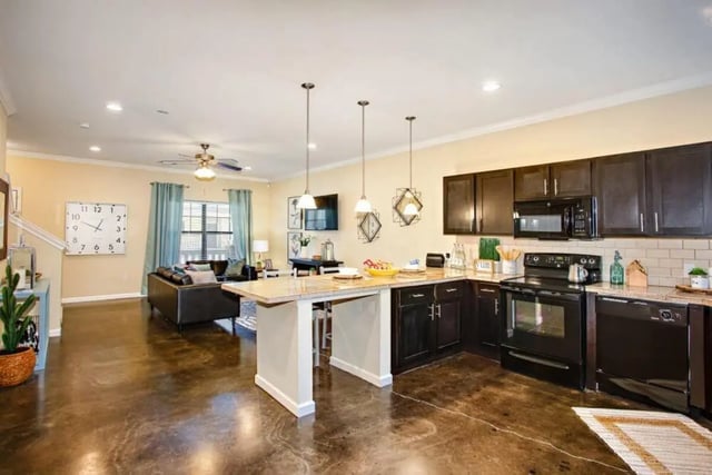 Kitchen island couch and appliances kitchen at The Collective At Clemson in Clemson Student Accommodation