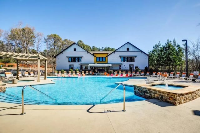 Pool with lounge chairs and a building exterior at The Collective At Clemson in Clemson Student Accommodation