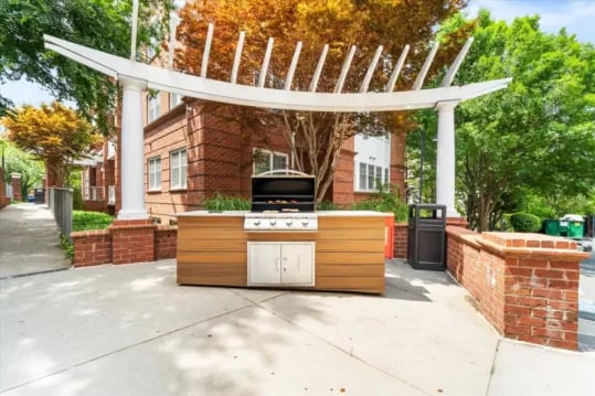 Outdoor grill with wooden cabinetry and brick patio exterior at Wertland Square in Charlottesville Student Accommodation