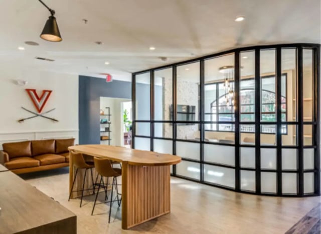 Leather sofa bar island and glass partitioned meeting room Living room at Wertland Square in Charlottesville Student Accommodation
