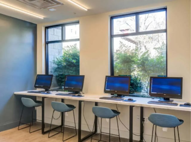 Computers and chairs by windows Study Area at Wertland Square in Charlottesville Student Accommodation