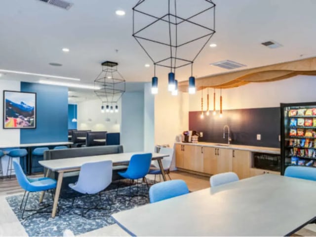 Dining tables chairs and kitchenette Image Type Common Area at Wertland Square in Charlottesville Student Accommodation