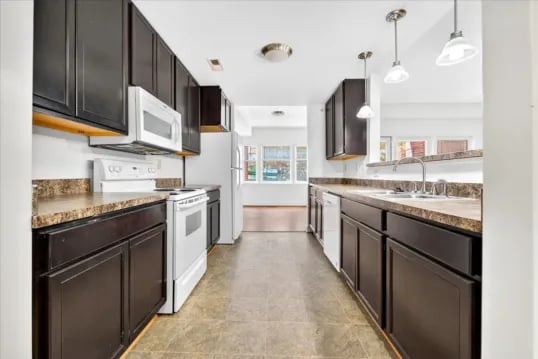 Dark cabinets white appliances and countertops kitchen at Wertland Square in Charlottesville Student Accommodation