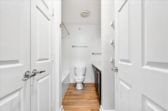 Toilet and vanity area through white doors bathroom at Wertland Square in Charlottesville Student Accommodation