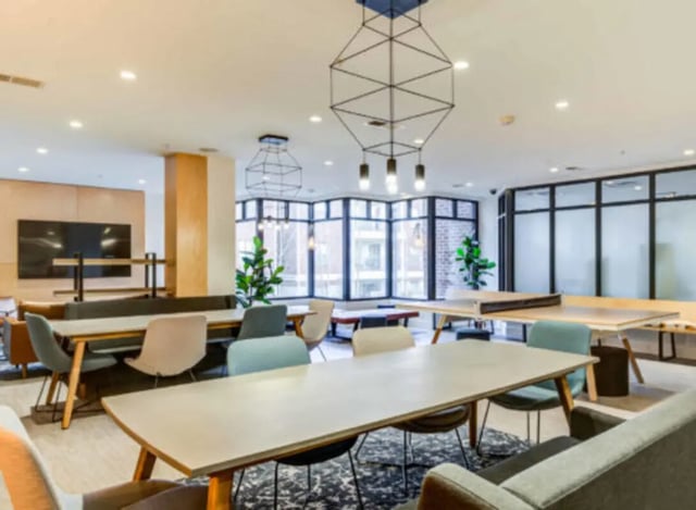 Dining tables chairs and ping pong table lounge area at Wertland Square in Charlottesville Student Accommodation