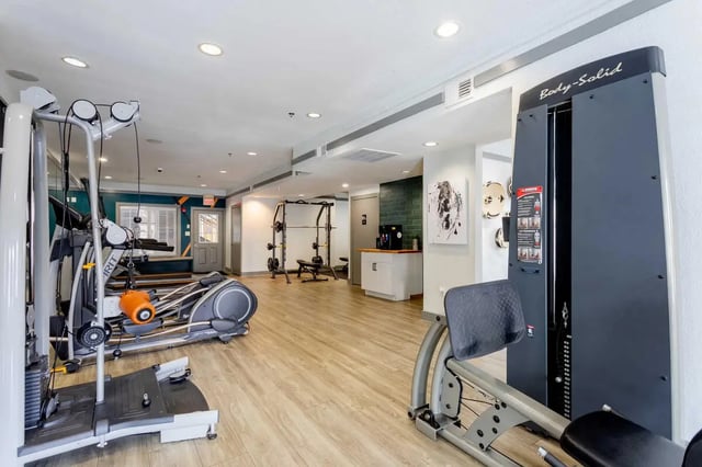 Fitness machines including leg press and elliptical gym at The Commons at Knoxville in Knoxville Student Accommodation