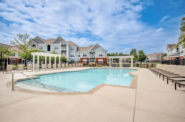 Swimming pool with lounge chairs exterior at The Lodge on the Trail Apartments in West Lafayette Student Accommodation