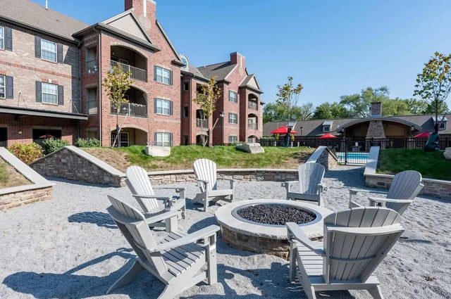 Adirondack chairs around a fire pit exterior at Miami Preserve in Oxford Student Accommodation