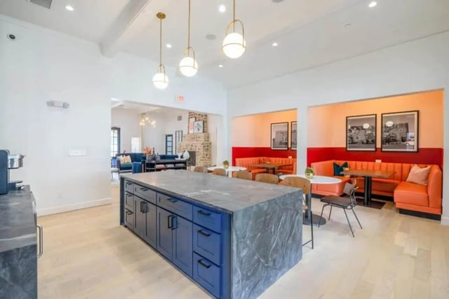 Kitchen island with blue cabinets and seating area at The Collective At Lubbock in Lubbock Student Accommodation