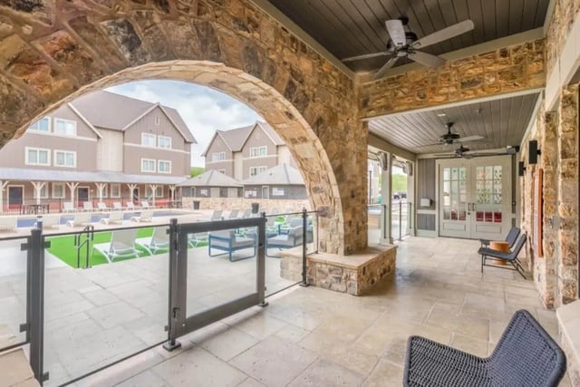 Archway view of poolside lounge and buildings exterior at The Collective At Lubbock in Lubbock Student Accommodation