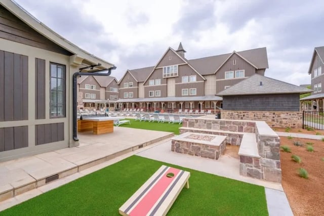 Cornhole game fire pit lounge chairs exterior at The Collective At Lubbock in Lubbock Student Accommodation