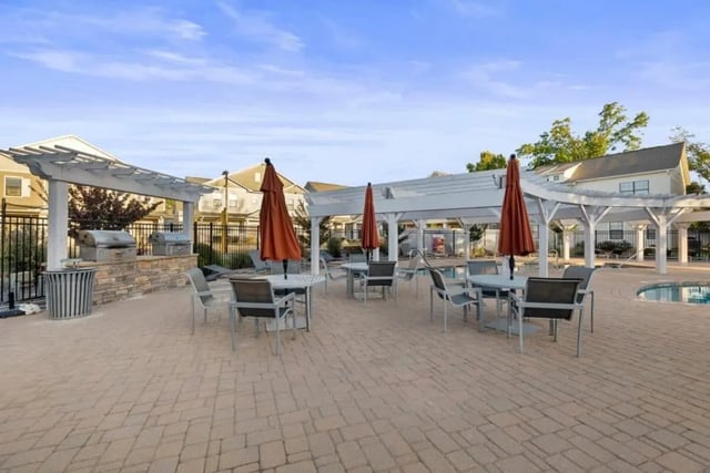 Grills tables chairs umbrellas outdoor seating area exterior at The Collective At Norman in Norman Student Accommodation