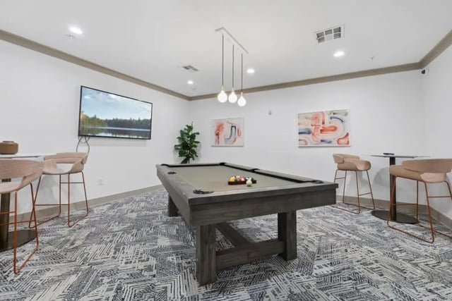 Pool table bar stools TV abstract art game room at The Collective At Norman in Norman Student Accommodation