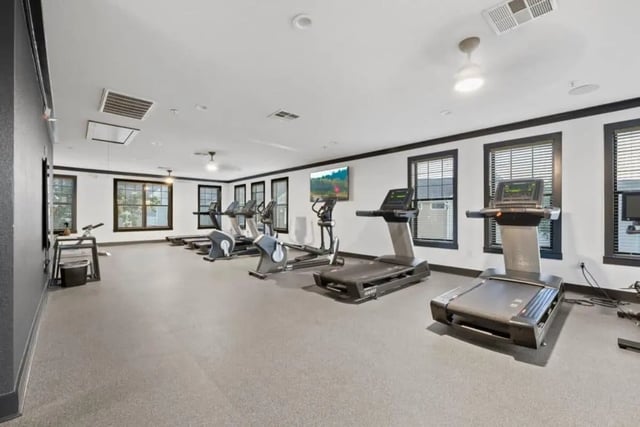 Treadmills and elliptical machines in a gym area at The Collective At Norman in Norman Student Accommodation