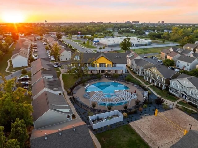 Apartment complex with pool and volleyball court exterior at The Collective At Norman in Norman Student Accommodation
