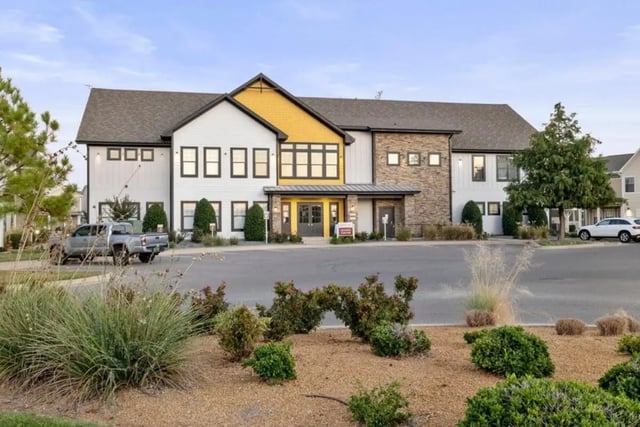 Modern apartments with grey truck and landscaping exterior at The Collective At Norman in Norman Student Accommodation