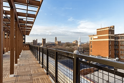 Wooden deck balcony with city skyline view exterior at The Archive in New Haven Student Accommodation