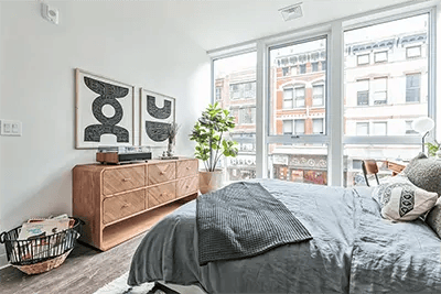 Bed dresser artwork and plant bedroom at The Archive in New Haven Student Accommodation