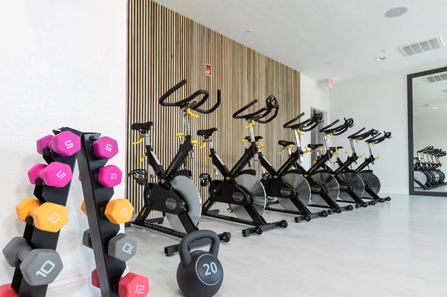 Spin bikes dumbbells and kettlebell fitness area at The Collective at Columbia in Columbia Student Accommodation