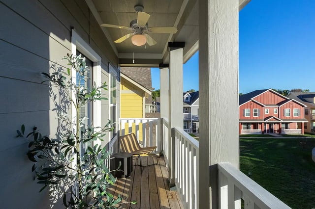 Chair and table on balcony overlooking houses exterior at The Collective at Columbia in Columbia Student Accommodation